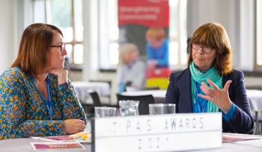 Two staff members in conversation