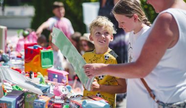 Boy picking out toys and smiling (Aug 2023)