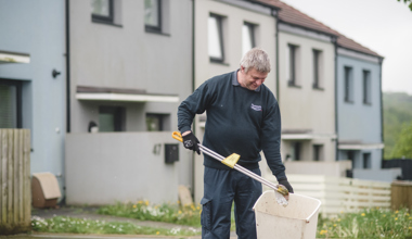 Member of staff picking up rubbish