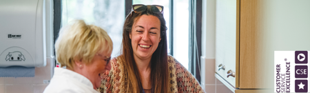 A person smiling with sunglasses on her head

AI-generated content may be incorrect.
