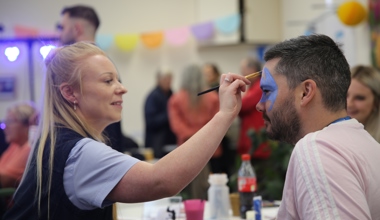 Staff face painting resident