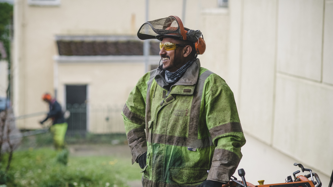 Member of staff cutting grass